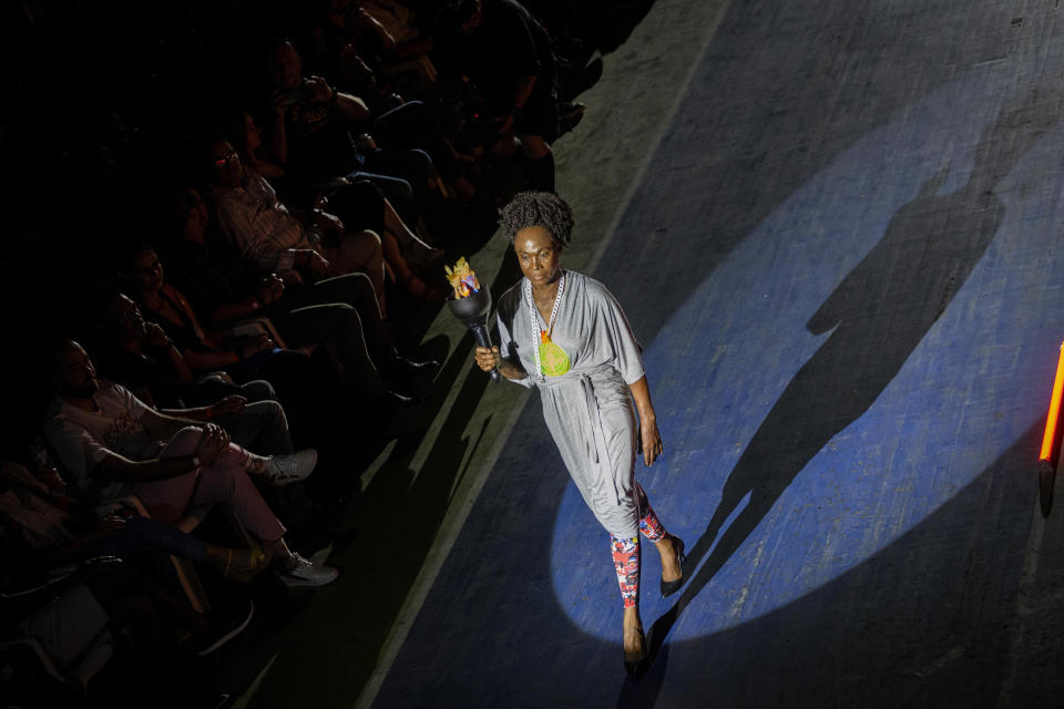 Former 800-meter star and two time world champion, Cuban Ana Fidelia Quirot, wears a creation from "Clandestina," the first Cuban independent urban fashion brand, during a launches for the 2020 collection called Sports Glories in Havana, Cuba, Friday, Nov. 22, 2019. (AP Photo/Ramon Espinosa)