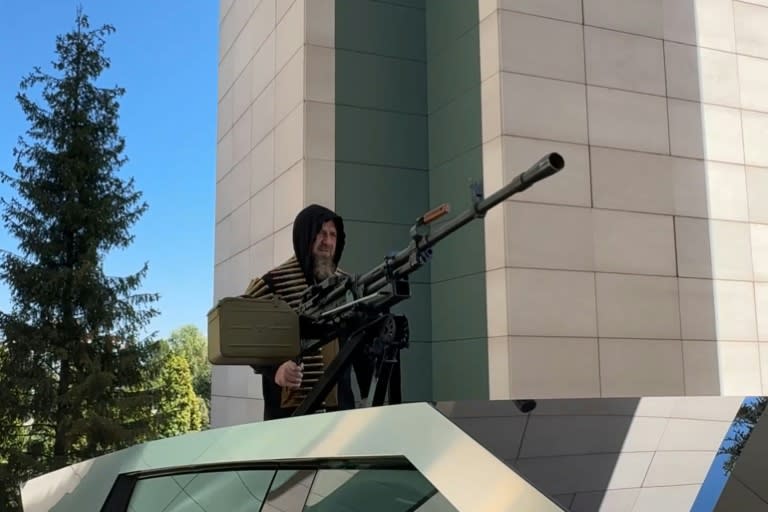 This video grab taken from a handout footage released on the official Telegram account of the Head of Chechen Republic on August 17, 2024, shows Chechen leader Ramzan Kadyrov standing atop a gun-mounted Tesla Cybertruck in Grozny, Chechnya. (Handout)