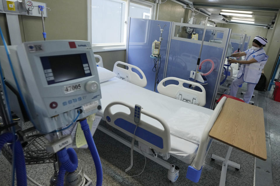 A health worker prepares equipment in a field hospital for COVID-19 patients at the 11th Army Region base in Bangkok, Thailand, Friday, July 2, 2021. As Thailand faces growing numbers of COVID-19 cases and related deaths during a devastating third wave of the coronavirus, there are concerns that it will face a shortage of hospital beds, intensive care units and ventilators for seriously ill patients. (AP Photo/Sakchai Lalit)