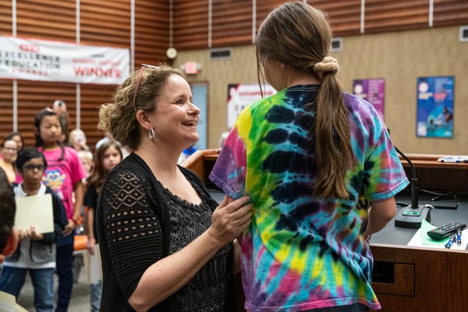 Rachel Beavers, the global problem solving teacher for Windsor Park, comforts third grade student Logan Pulich who is nervous for a debate on community gardens on Tuesday, Oct. 24, 2023, in Corpus Christi, Texas.