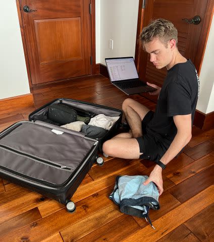 <p>Luke Scarpino </p> Luke Scarpino packing a suitcase using the packing spreadsheet he created.