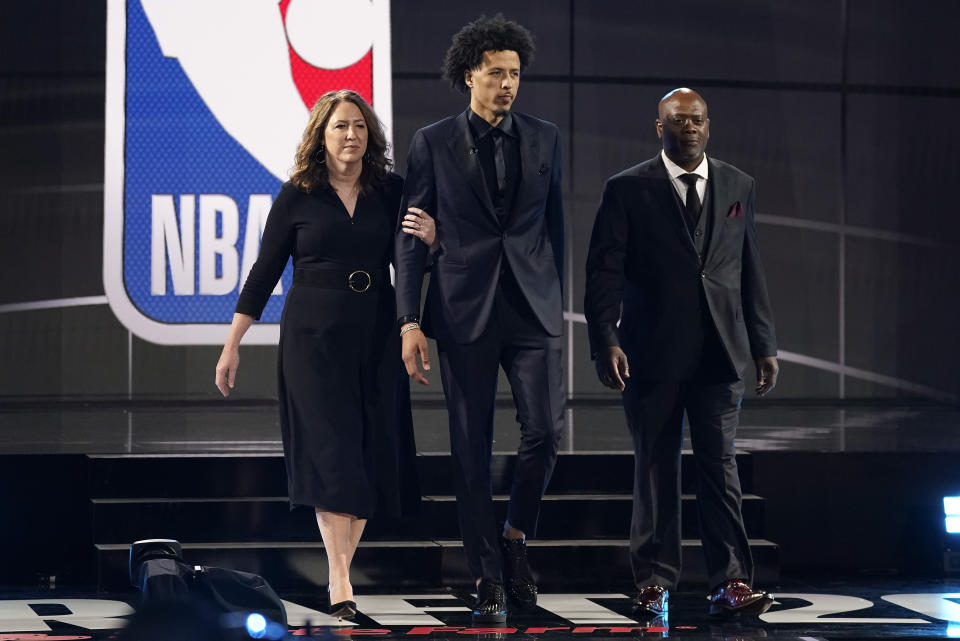 Cade Cunningham, center, walks with his parents, Carrie, left, and Keith Cunningham during the NBA basketball draft, Thursday, July 29, 2021, in New York. Cunningham was selected first overall by the Detroit Pistons. - Credit: AP