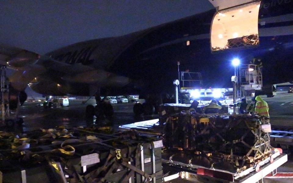 Workers unload a shipment of military aid delivered as part of the United States of America's security assistance to Ukraine - REUTERS