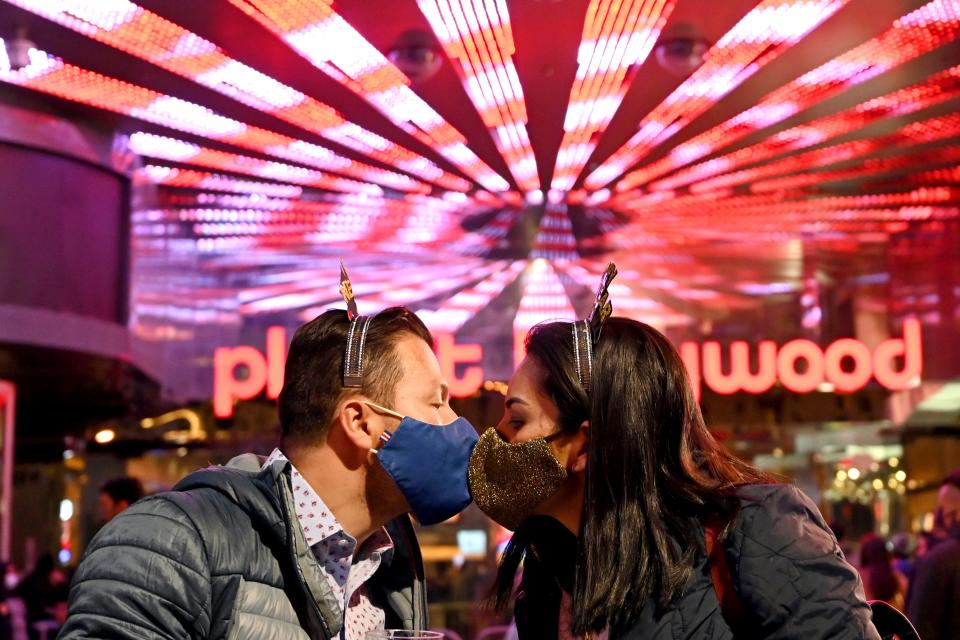 A couple kiss as they celebrate New Year's Eve along the Las Vegas Strip Thursday, Dec 31, 2020, in Las Vegas.
