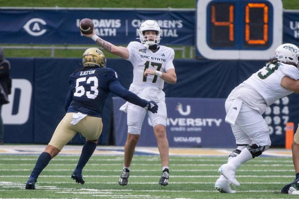 Sacramento State Hornets quarterback Carson Conklin (17) attempts to pass downfield as UC Davis Aggies linebacker Nick Eaton (53) puts on pressure in the first half of the Causeway Classic on Saturday at UC Davis Health Stadium.