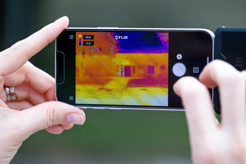 Sarah Terry-Cobo, associate planner with Oklahoma City's Office of Sustainability, shows thermal imaging via her phone Saturday outside Will Rogers Senior Center in-between sessions with volunteers for an urban heat island mapping event in Oklahoma City.