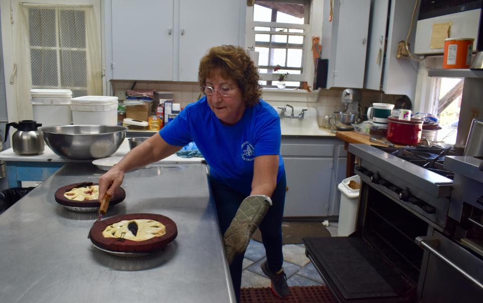 Jeannine Ridgeway slides a pair of pies into the oven at Tantillo's Farm Market in Gardiner.