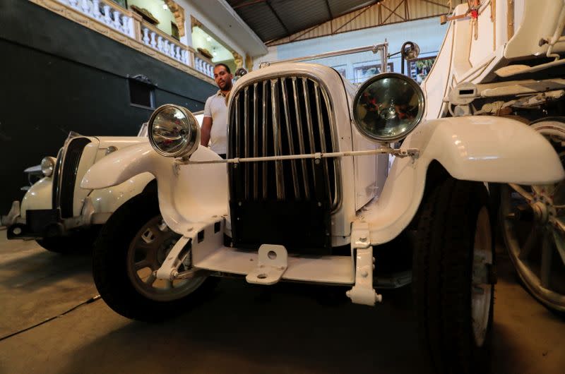 Ayman Sima, the 38-years-old son of Sayed Sima, an Egyptian collector of vintage cars, speaks during an interview with Reuters next to an Italian 1928 "FIAT 501" automobile at his father's store where he also has an exhibition of old cars, in Giza