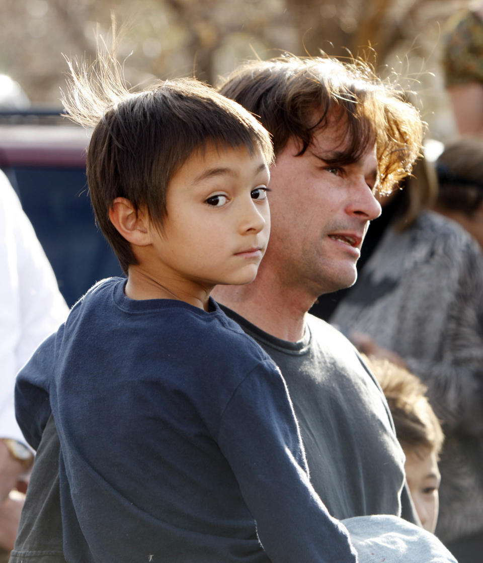 In this Oct. 15, 2009 file photo, six-year-old Falcon Heene is shown with his father, Richard, outside the family's home in Fort Collins, Colo., after Falcon Heene was found hiding in a box in a space above the garage.