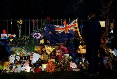 A woman pays her respects at a memorial site for victims of the mosque shootings at the Botanic Gardens in Christchurch, New Zealand, March 17, 2019. REUTERS/Jorge Silva