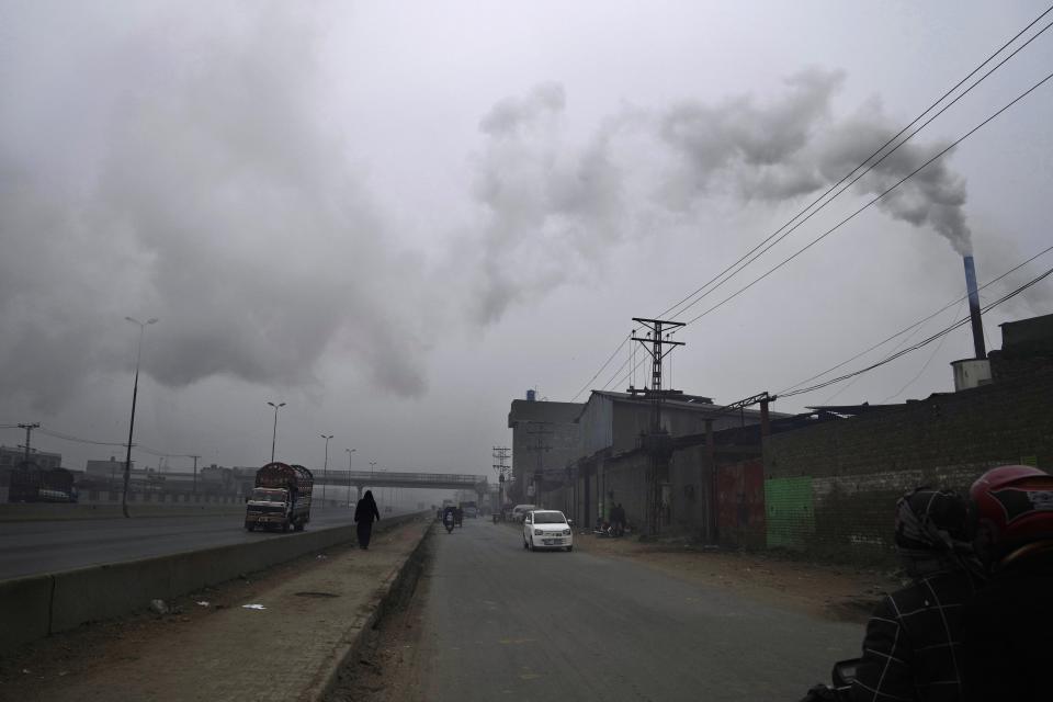 Smoke releases from a chimney of a small factory in Lahore, Pakistan, Tuesday, Jan. 16, 2024. Lahore has seen flight cancellations, school closures, factory shutdowns, and artificial rain to get things under control — but nothing seems to be working. (AP Photo/K.M. Chaudary)