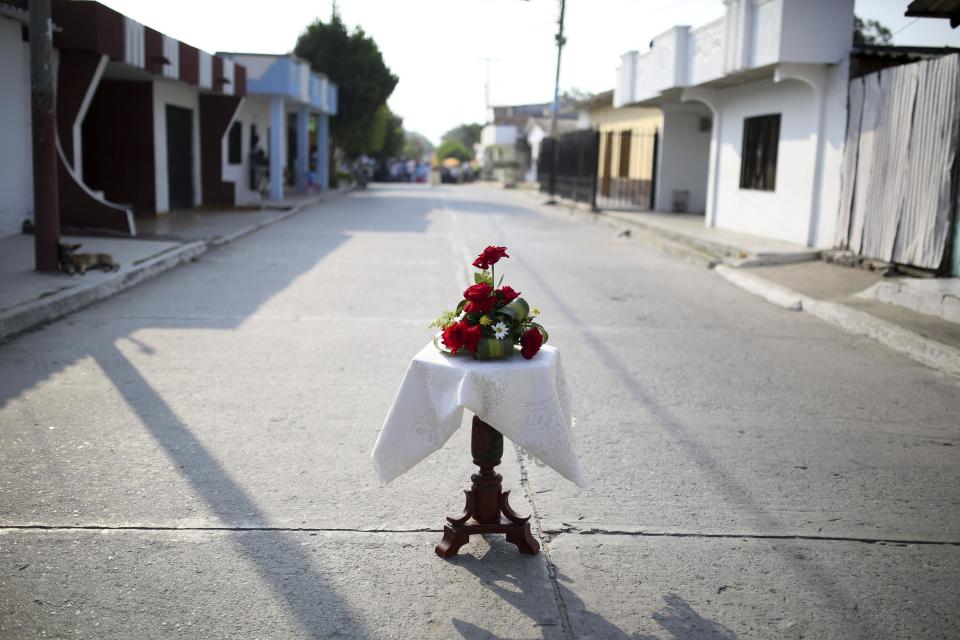 A table with flowers stands on the street as part of Good Friday celebrations in Aracataca, the hometown of late Nobel laureate Gabriel Garcia Marquez in Colombia's Caribbean coast, Friday, April 18, 2014. Since the author died Thursday at the age of 87, residents and holiday makers have been flocking to the home where he was born and raised by his maternal grandparents until the age of 8, paying their final respects to a man who was a symbol of pride for a country long torn by violence. (AP Photo/Ricardo Mazalan)