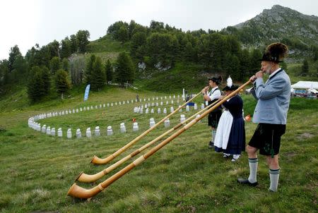 Alphorn blowers perform an ensemble piece on the last day of the Alphorn International Festival on the alp of Tracouet in Nendaz, southern Switzerland, July 22, 2018. REUTERS/Denis Balibouse
