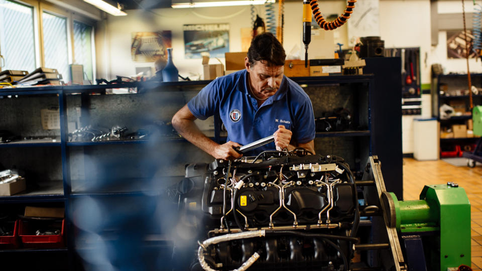 A craftsman at Alpina applies his expertise on an engine. - Credit: Katja Kuhl, courtesy of BMW.