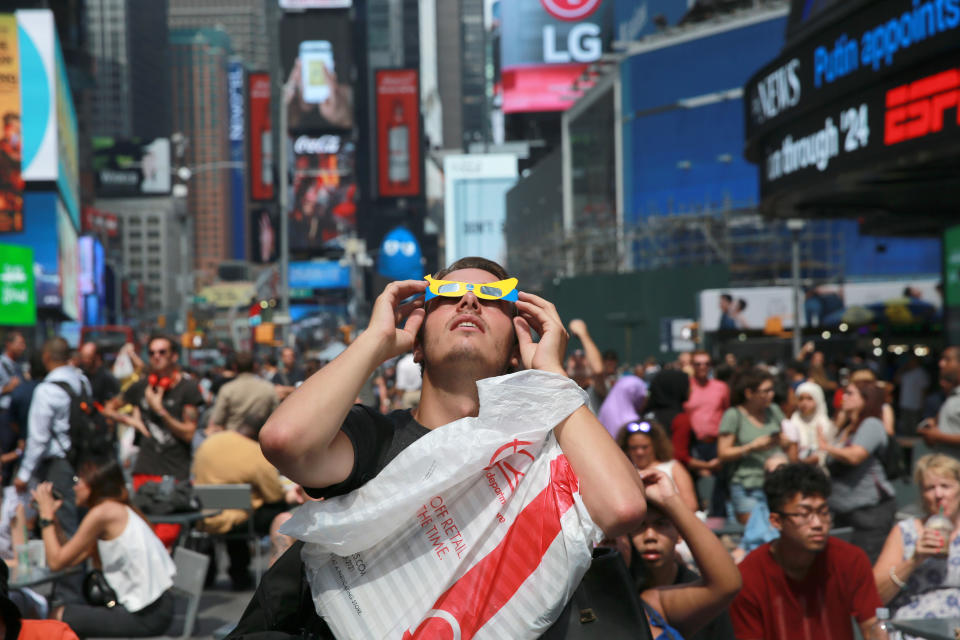 <p>A man looks up at the sun in Times Square, New York City, to watch the total solar eclipse on Aug. 21, 2017. (Gordon Donovan/Yahoo News) </p>