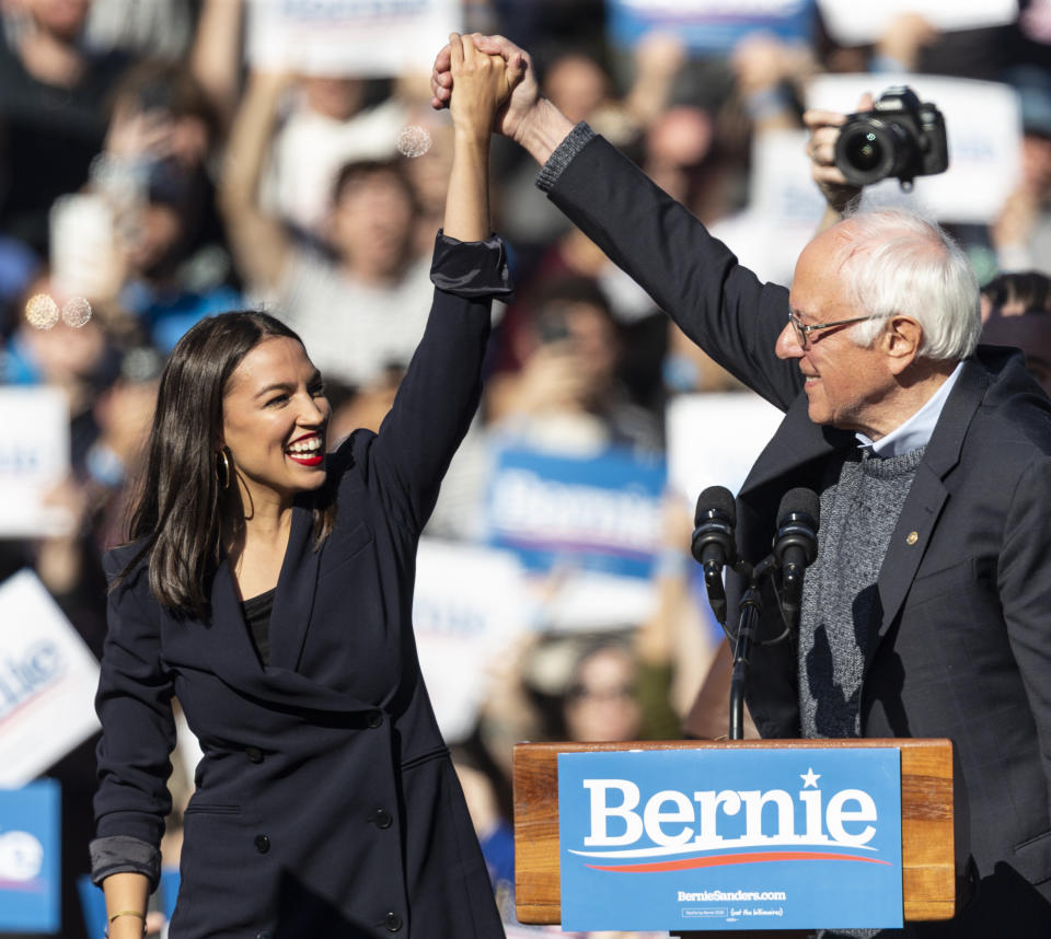 Democratic presidential candidate Sen. Bernie Sanders (I-Vt.) joins hands with Rep. Alexandria Ocasio-Cortez (D-N.Y.) during a campaign rally on Saturday in New York. (Photo: Pacific Press/Getty Images)