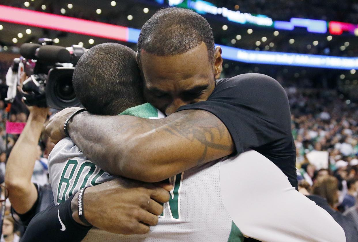 The Cleveland Cavaliers’ LeBron James, right, hugs the Boston Celtics’ Kyrie Irving following their game in Boston on Feb. 11. (Photo: AP/Michael Dwyer)