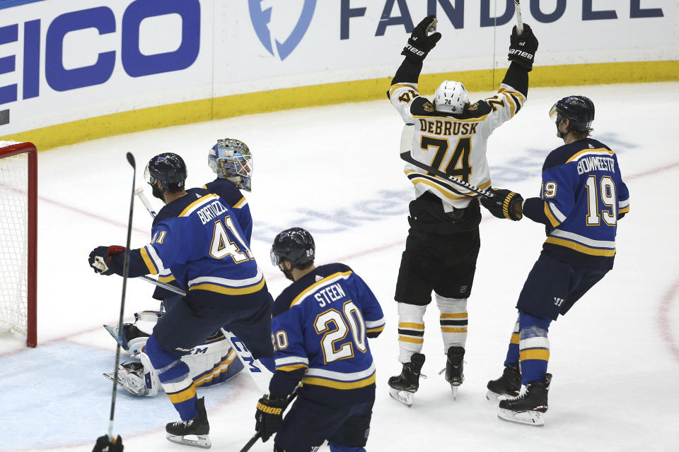 Boston Bruins left wing Jake DeBrusk (74) celebrates after teammate Patrice Bergeron, not shown, scored a goal against the St. Louis Blues during the first period of Game 3 of the NHL hockey Stanley Cup Final Saturday, June 1, 2019, in St. Louis. (AP Photo/Scott Kane)