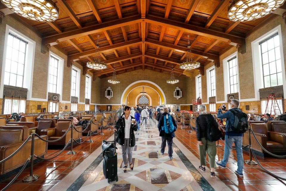 Passengers walk through the main lobby of the historic Los Angeles Union Station.