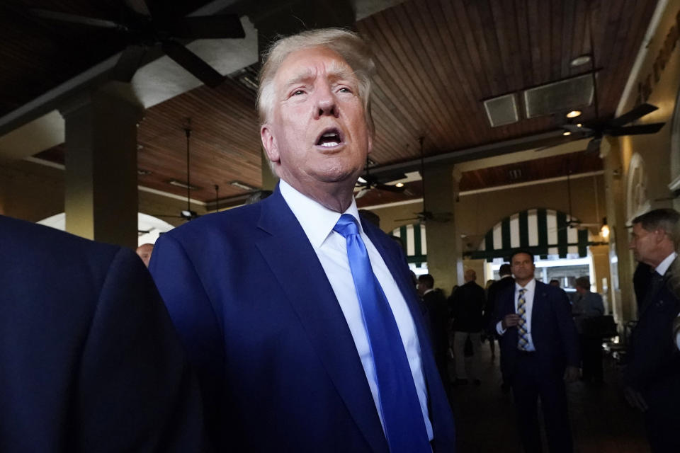 FILE - Former President Donald Trump visits Café du Monde in New Orleans, July 25, 2023. Republicans are responding to a late summer spike in COVID-19 by raising familiar fears that government-issued lockdowns and mask mandates are on the horizon. GOP presidential hopefuls including Florida Gov. Ron DeSantis, South Carolina Sen. Tim Scott and former President Donald Trump have spread this narrative. (AP Photo/Gerald Herbert, File)