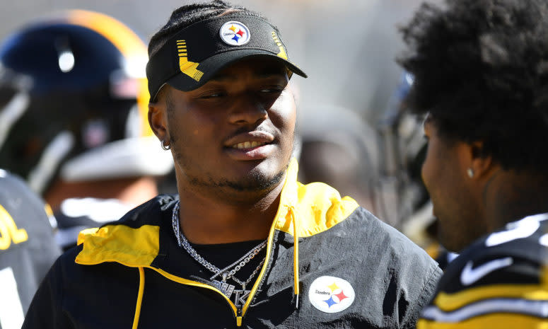 Steelers quarterback Dwayne Haskins looks on from the sidelines during a game.