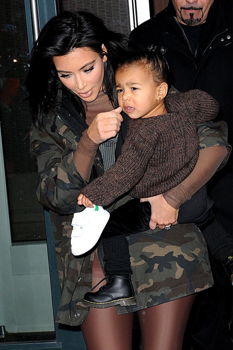 Not feeling the FROW: Kim had to carry baby North backstage after she started crying midway through the show (Picture: ACE Pictures/REX) ( ACE Pictures/REX)