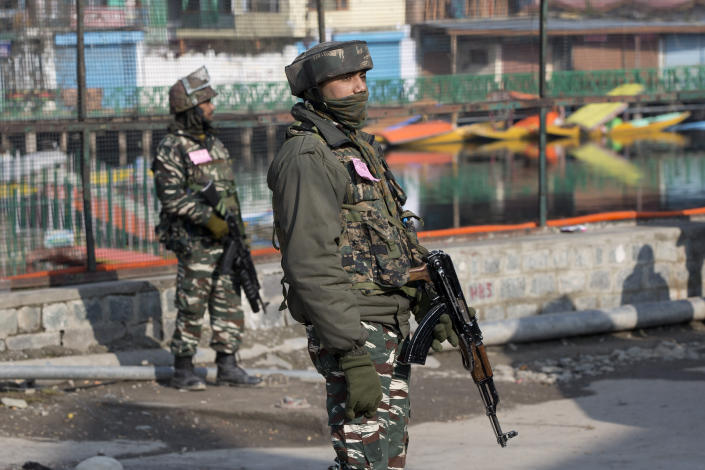 Indian paramilitary soldiers stand guard during a strike in Srinagar, Indian controlled Kashmir, Sunday, Feb. 3, 2019. India's prime minster is in disputed Kashmir for a daylong visit Sunday to review development work as separatists fighting Indian rule called for a shutdown in the Himalayan region. (AP Photo/Dar Yasin)