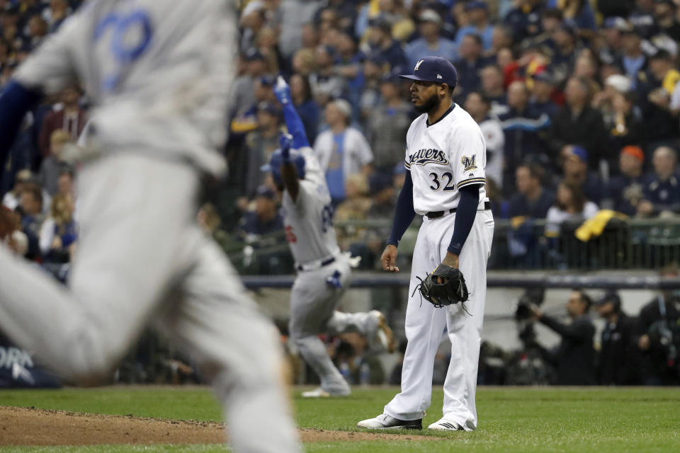 Milwaukee Brewers' Jeremy Jeffress (32) watches after giving up a three-run home run to Los Angeles Dodgers' Yasiel Puig during the sixth inning of Game 7 of the National League Championship Series baseball game Saturday, Oct. 20, 2018, in Milwaukee. (AP Photo/Jeff Roberson)