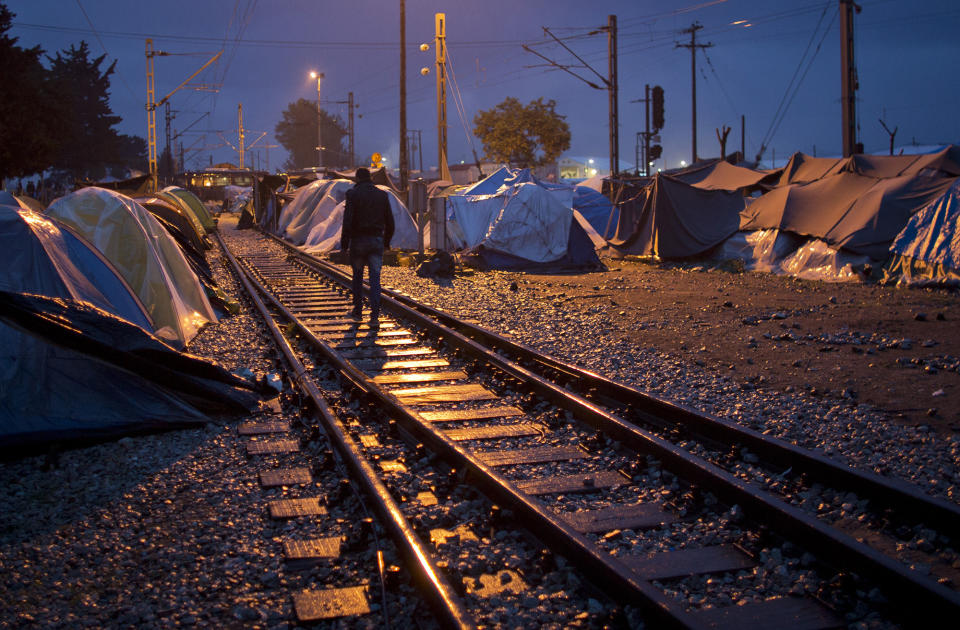 <p>A migrant walks on railway tracks at the migrant camp in Idomeni, Greece, May 20, 2016. Thousands of stranded refugees and migrants have camped in Idomeni for months after the border was closed. (Darko Bandic/AP) </p>