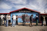 A crowd of people consisting of residents from California and Nevada lines up outside the Arizona Last Stop convenience store and souvenir shop to buy Powerball tickets, Tuesday, Nov. 27, 2012, in White Hills, Ariz. There has been no Powerball winner since Oct. 6, and the jackpot already has reached a record level for the game. (AP Photo/Julie Jacobson)