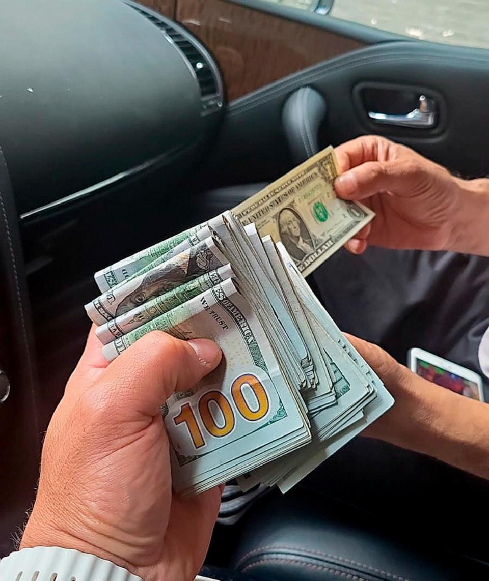 PHOTO: In this June 2023 photo provided by the U.S. Attorney's Office, an undercover agent posing as a hitman holds money received as an advance payment for the murder of Gurpatwant Singh Pannun, an American citizen, during a transaction in New York. (U.S. Attorney's Office via AP, FILE)