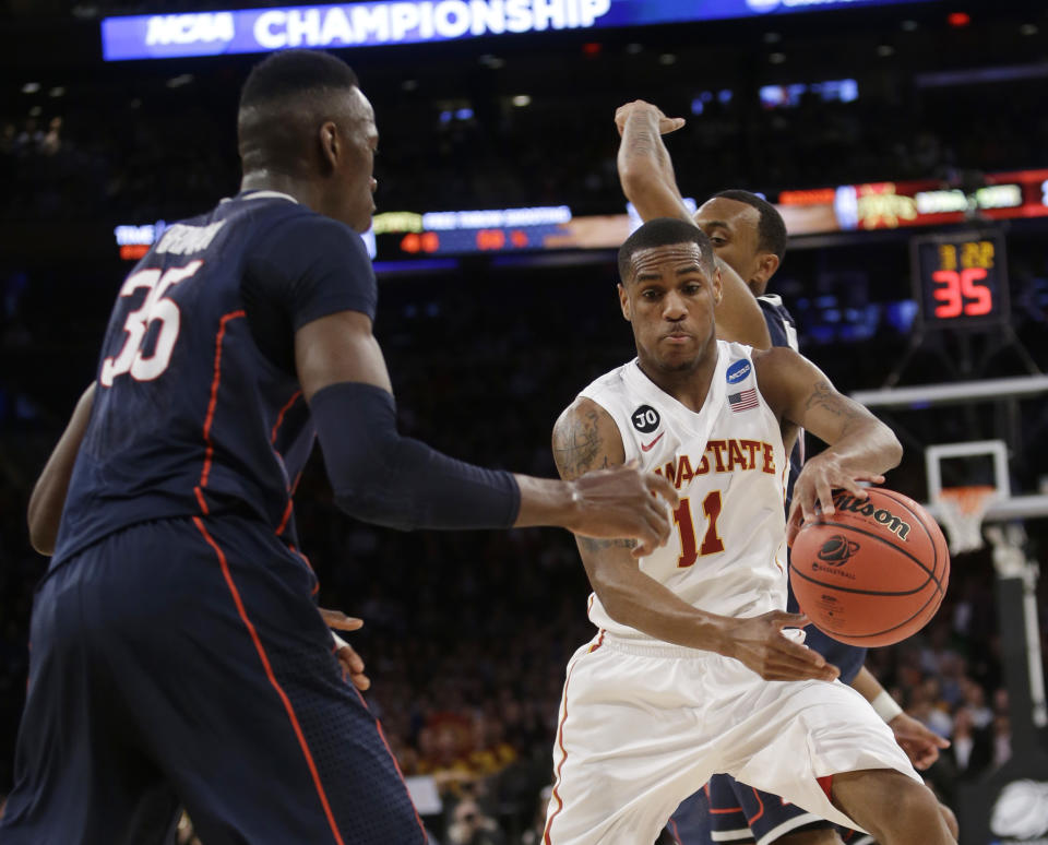 Iowa State's Monte Morris, right, moves the ball around Connecticut's Amida Brimah, left, during the first half in a regional semifinal of the NCAA men's college basketball tournament Friday, March 28, 2014, in New York. (AP Photo/Frank Franklin II)