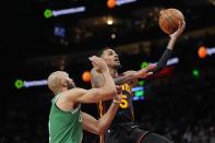 Atlanta Hawks guard Dejounte Murray (5) goes in for a shot as Boston Celtics guard Derrick White (9) defends during the first half of an NBA basketball game Thursday, March 28, 2024, in Atlanta. (AP Photo/John Bazemore)