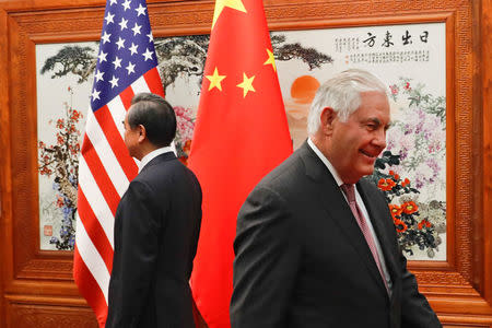 U.S. Secretary of State Rex Tillerson (R) walks by Chinese Foreign Minister Wang Yi before a meeting at the Great Hall of the People in Beijing, China September 30, 2017. REUTERS/Andy Wong/Pool