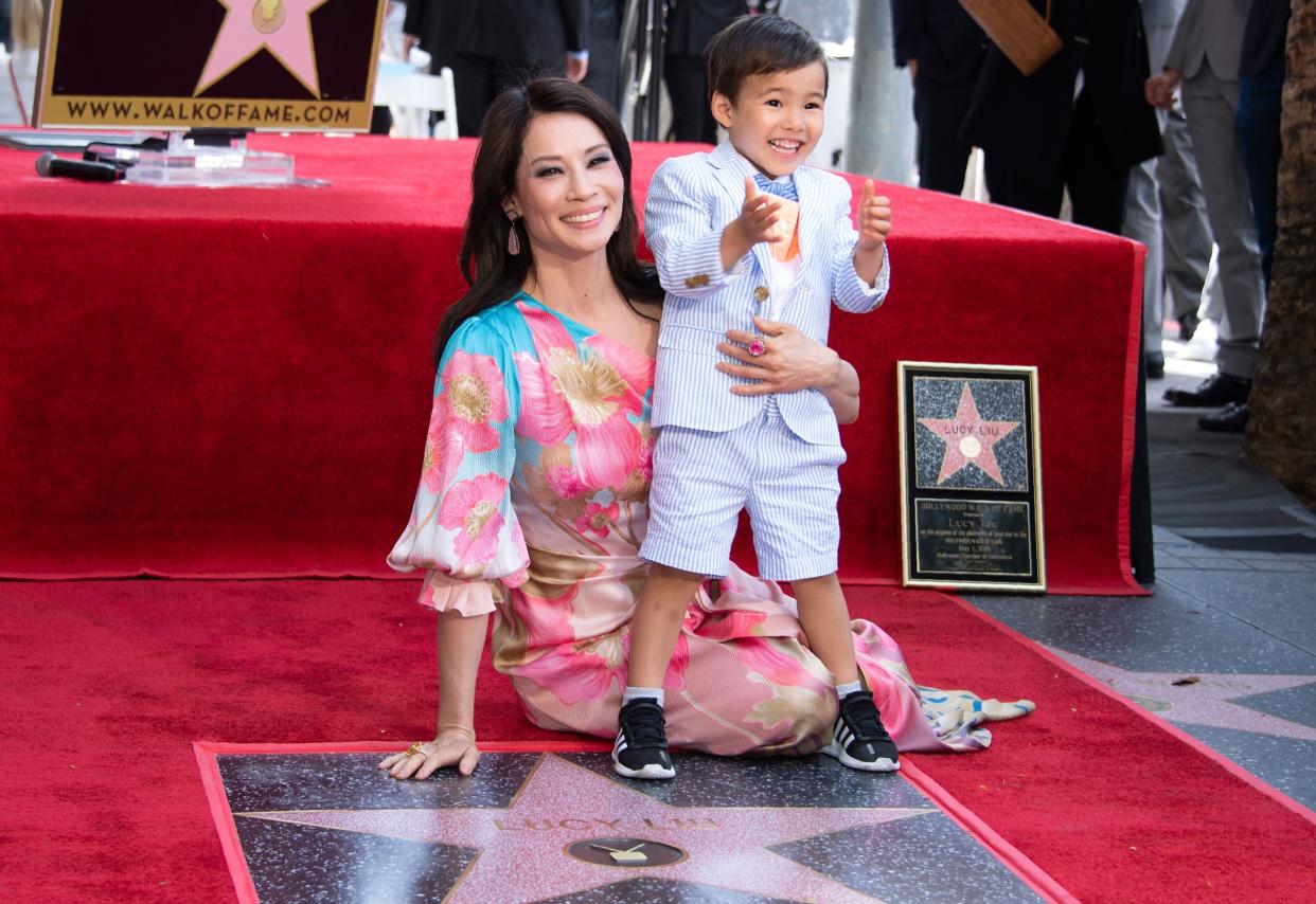 Lucy Liu and her son Rockwell Lloyd smile as she receives her star on the Walk of Fame during a ceremony in Hollywood in May 2019. (Photo: VALERIE MACON via Getty Images)