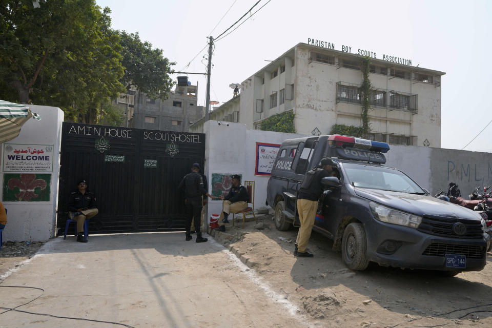 Police officers stand guard outside a deportation center setup by authorities to facilitate illegal immigrants in Karachi, Pakistan, Wednesday, Nov. 1, 2023. Pakistani security forces on Wednesday rounded up, detained and deported dozens of Afghans who were living in the country illegally, after a government-set deadline for them to leave expired, authorities said. (AP Photo/Fareed Khan)