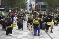 People kneel to protest during a solidarity rally for the death of George Floyd in Seoul, South Korea, Saturday, June 6, 2020. Floyd died after being restrained by Minneapolis police officers on May 25.(AP Photo/Ahn Young-joon)