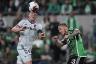 St Louis City FC defender Jake Nerwinski, left, heads the ball past Austin FC midfielder Ethan Finlay (13) during the second half of an MLS soccer match in Austin, Texas, Saturday, Feb. 25, 2023. (AP Photo/Eric Gay)