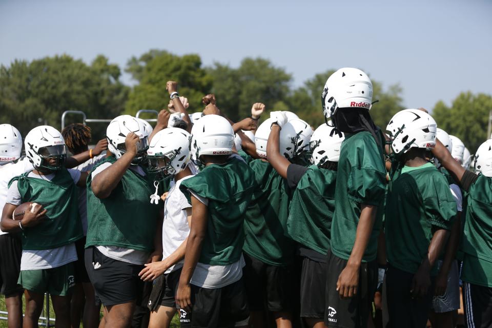 Players on the South Bend Washington football team break the huddle before practice Friday, August 4, 2023 at Washington High School in South Bend.