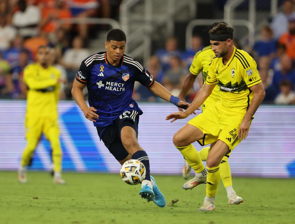 Sep 14, 2024; Cincinnati, Ohio, USA; FC Cincinnati defender Kevin Kelsy (19) battles Columbus Crew defender Rudy Camacho (4) for control of a ball during the second half at TQL Stadium. Mandatory Credit: Joseph Maiorana-Imagn Images