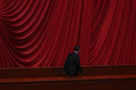 A delegates leaves the hall after Chinese Premier Li Qiang delivered his work report at the opening session of the National People's Congress (NPC) at the Great Hall of the People in Beijing, Tuesday, March 5, 2024. China's official growth target for this year is around 5%, Premier Li Qiang said Tuesday in an annual report on the government's plans and performance that prioritized both security and the economy. (AP Photo/Andy Wong)