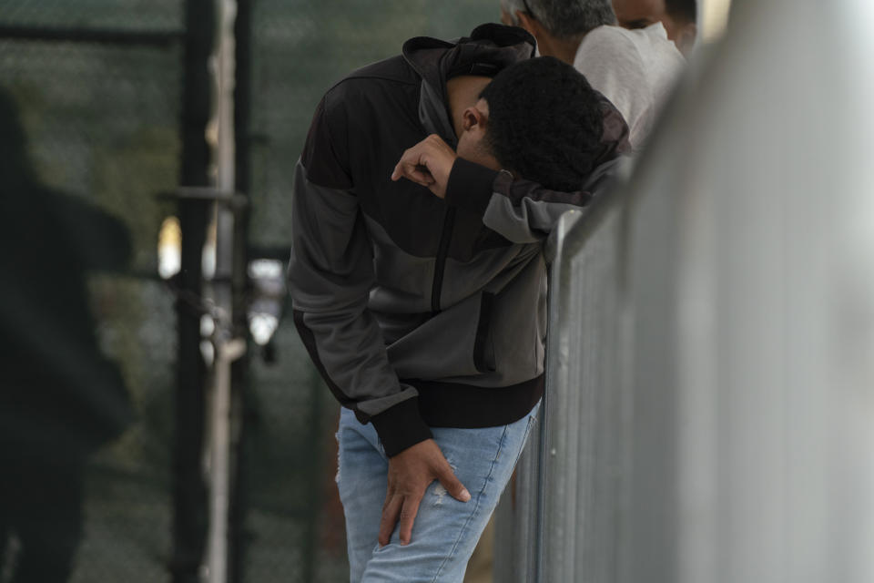 A migrant waits at the Gateway International Port of Entry under U.S. Customs and Border Protection custody in Brownsville, Texas, Friday, May 5, 2023, before being sent back to Mexico under Title 42. (AP Photo/Veronica G. Cardenas)