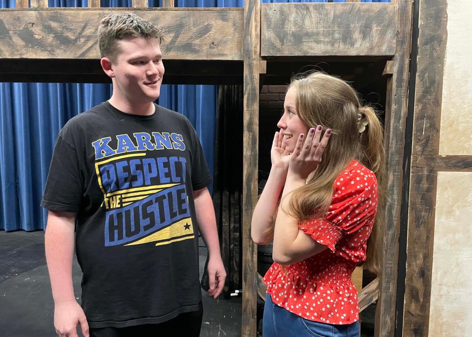 Jace Krugjohann, 17, who plays Mr. Bumble, and Miranda Watkins, 17, the Widow Corney, are all set to run lines during rehearsal for “Oliver!” at Karns High School, April 23, 2024.