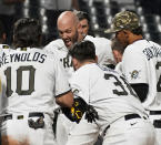 Pittsburgh Pirates catcher Jacob Stallings is mobbed by teammates after hitting a two-run home run against the San Francisco Giants in a baseball game Saturday May 15, 2021, in Pittsburgh. (Peter Diana/Pittsburgh Post-Gazette via AP)