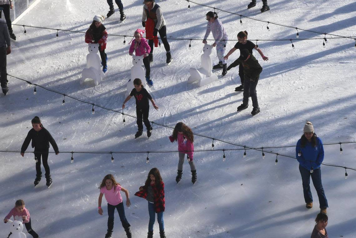 Skaters circle counter-clockwise at Hanford’s Winter Wonderland Wednesday, Dec. 28, 2022 in Hanford. Winter Wonderland, in its second year, features an ice rink in Civic Center Park. The festivities run every day through January 8.