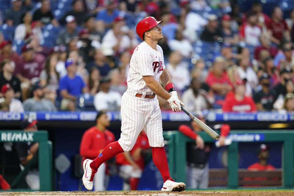 Philadelphia Phillies' J.T. Realmuto watches after hitting an RBI-sacrifice fly against Washington Nationals pitcher Paolo Espino during the fourth inning of a baseball game, Tuesday, July 5, 2022, in Philadelphia. (AP Photo/Matt Slocum)