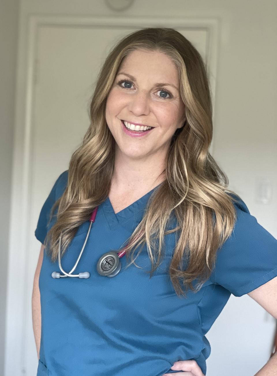 Smiling Julie in scrubs with a stethoscope around her neck poses confidently