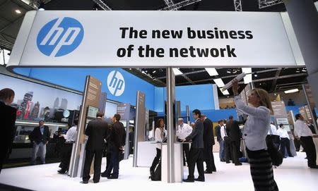 A visitor takes a photo with a tablet in front of a Hewlett-Packard (HP) stand at the Mobile World Congress in Barcelona, February 27, 2014. REUTERS/Albert Gea/Files