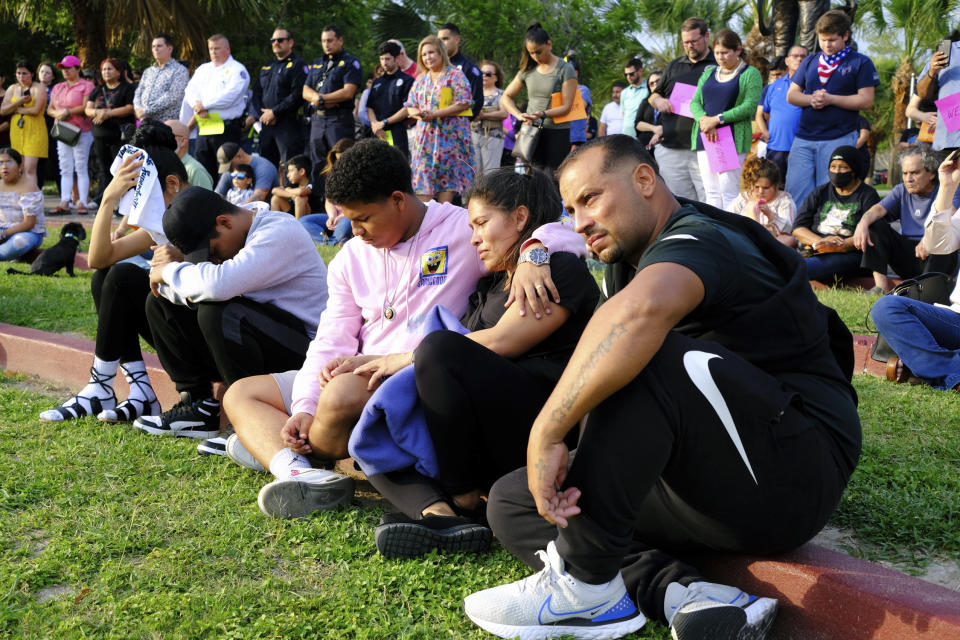 People attend a vigil at Linear Park in Brownsville, Texas, Monday, May 8, 2023. An SUV driver who killed eight people when he slammed into a group waiting at a bus stop in Brownsville was charged with manslaughter, police said Monday as investigators tried to determine if the crash was intentional. (Miguel Roberts/The Brownsville Herald via AP)