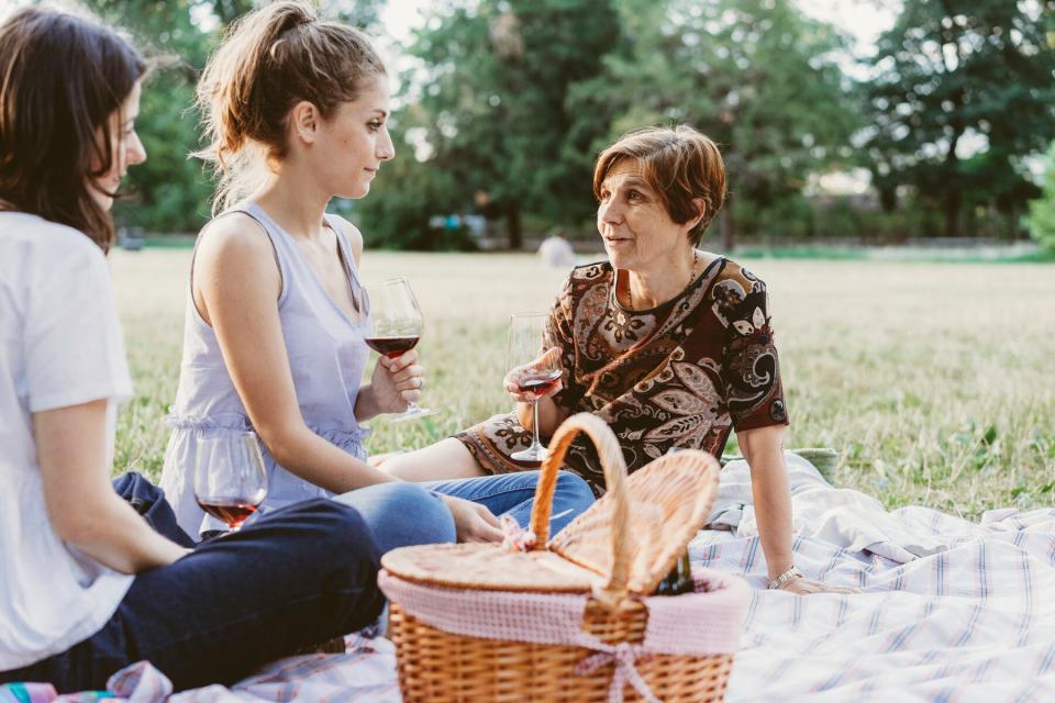 Mother and daughters having wine